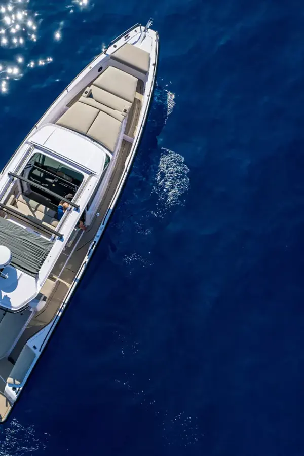 A modern Axopar 37 boat cruising over crystal clear turquoise waters off the Cretan coast